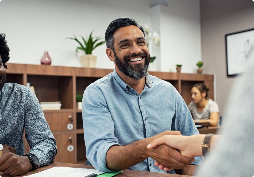 Smiling man shaking hands in an office